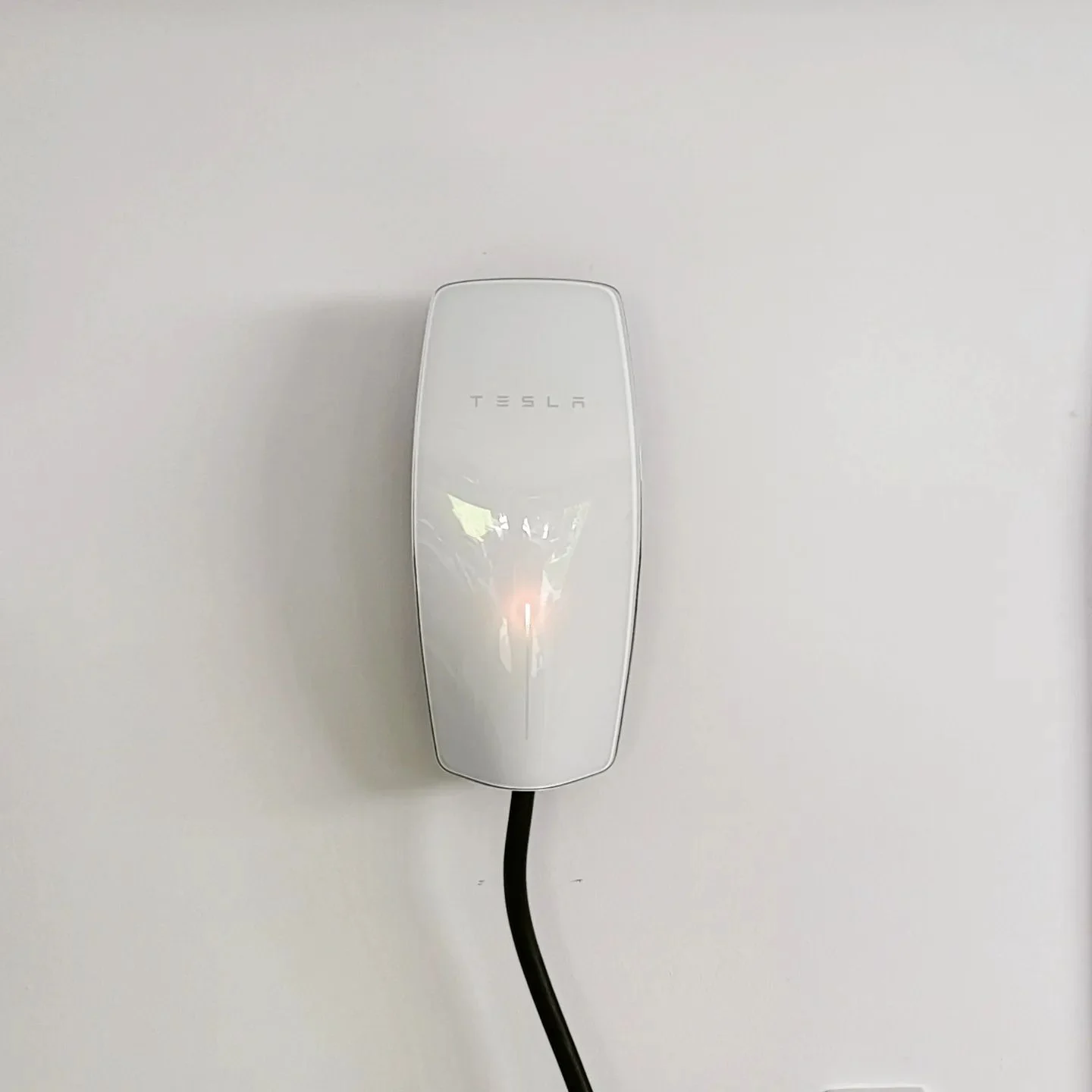 A wall-mounted white Tesla Wall Connector is installed, showing an example of professional EV Charger Installation in Geelong