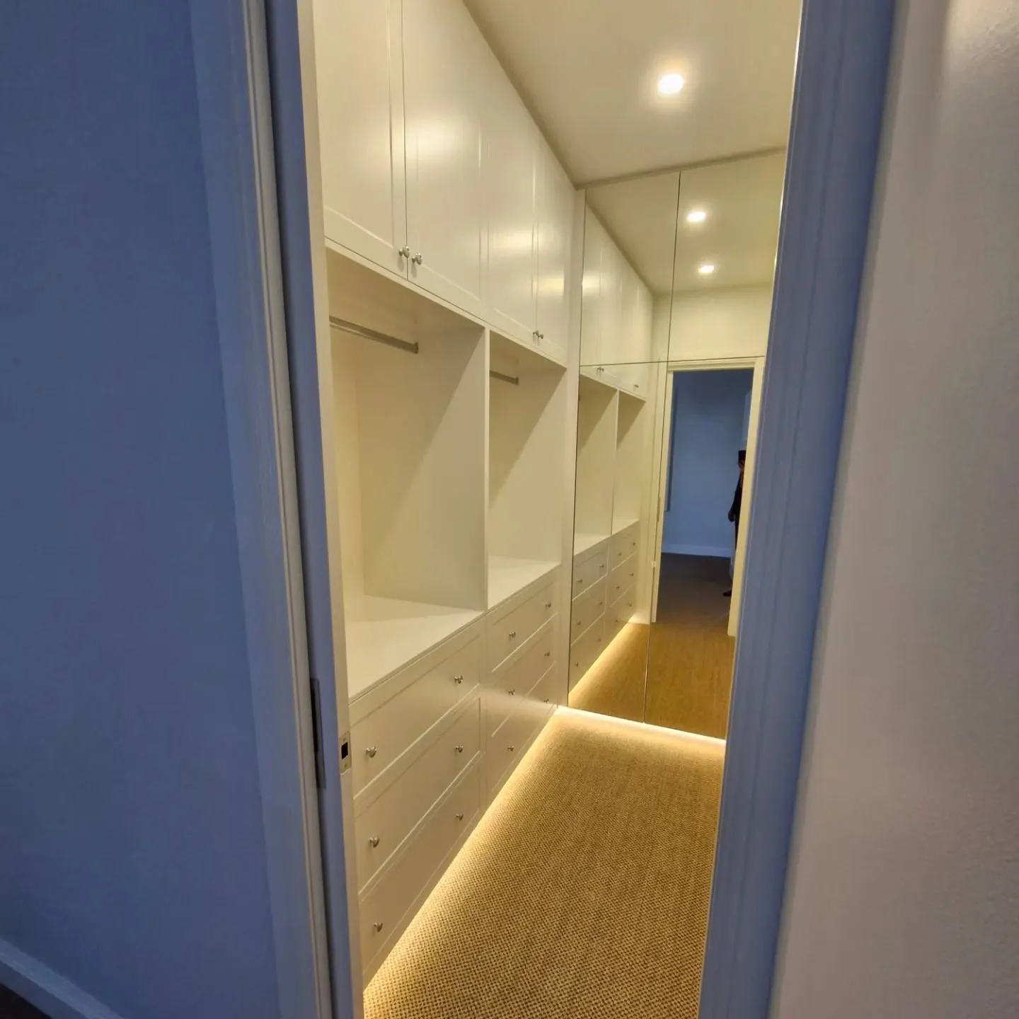 Walk in wardrobe white joinery ceiling downlights baseboard led strip lighting