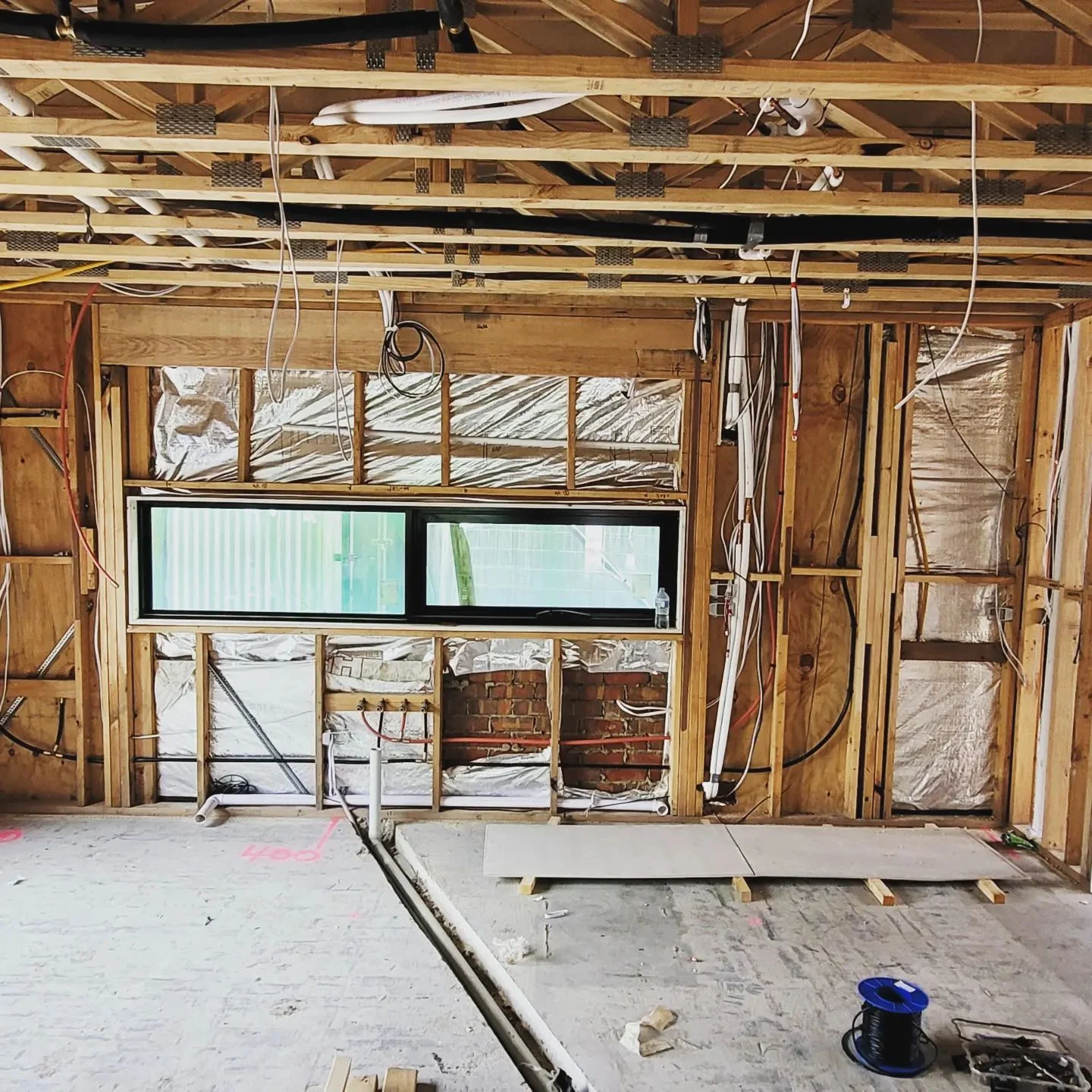 Timber frame home construction site wall rough in electrical wiring cable spools